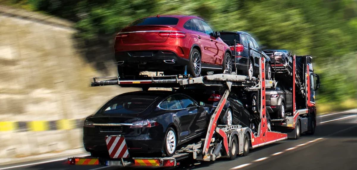 Fully loaded auto haul trailer driving on a highway